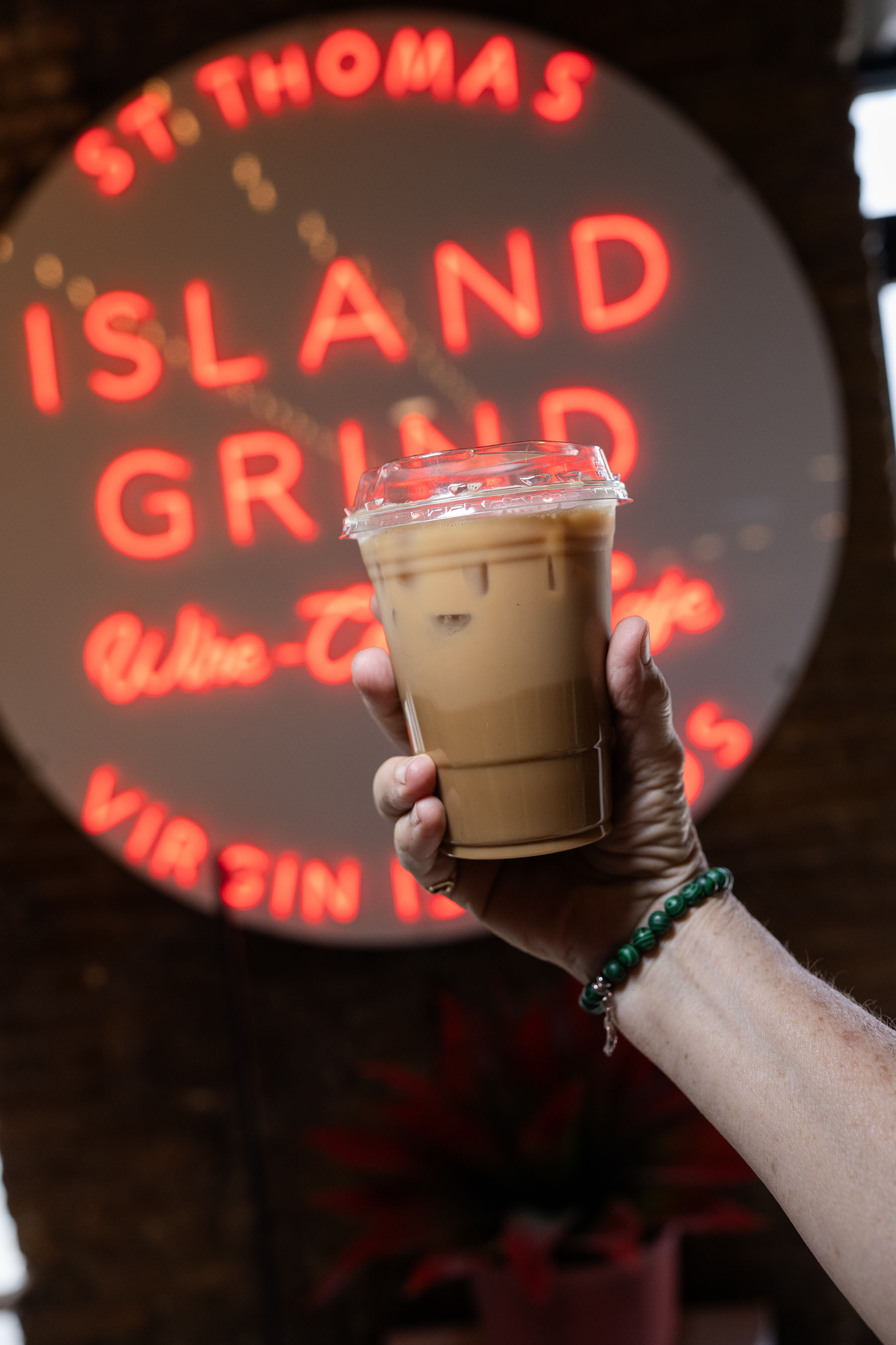 A cup of Island Grind coffee held on Main Street in the morning